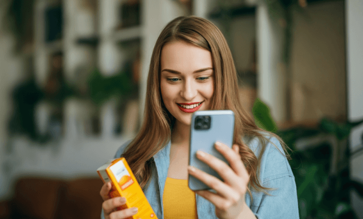 Consumer checking product details on phone after scanning.